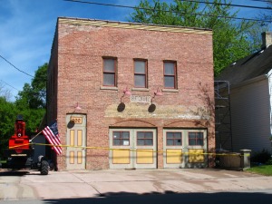 Photo of the front of the SAHS firehouse with progress made on restoration